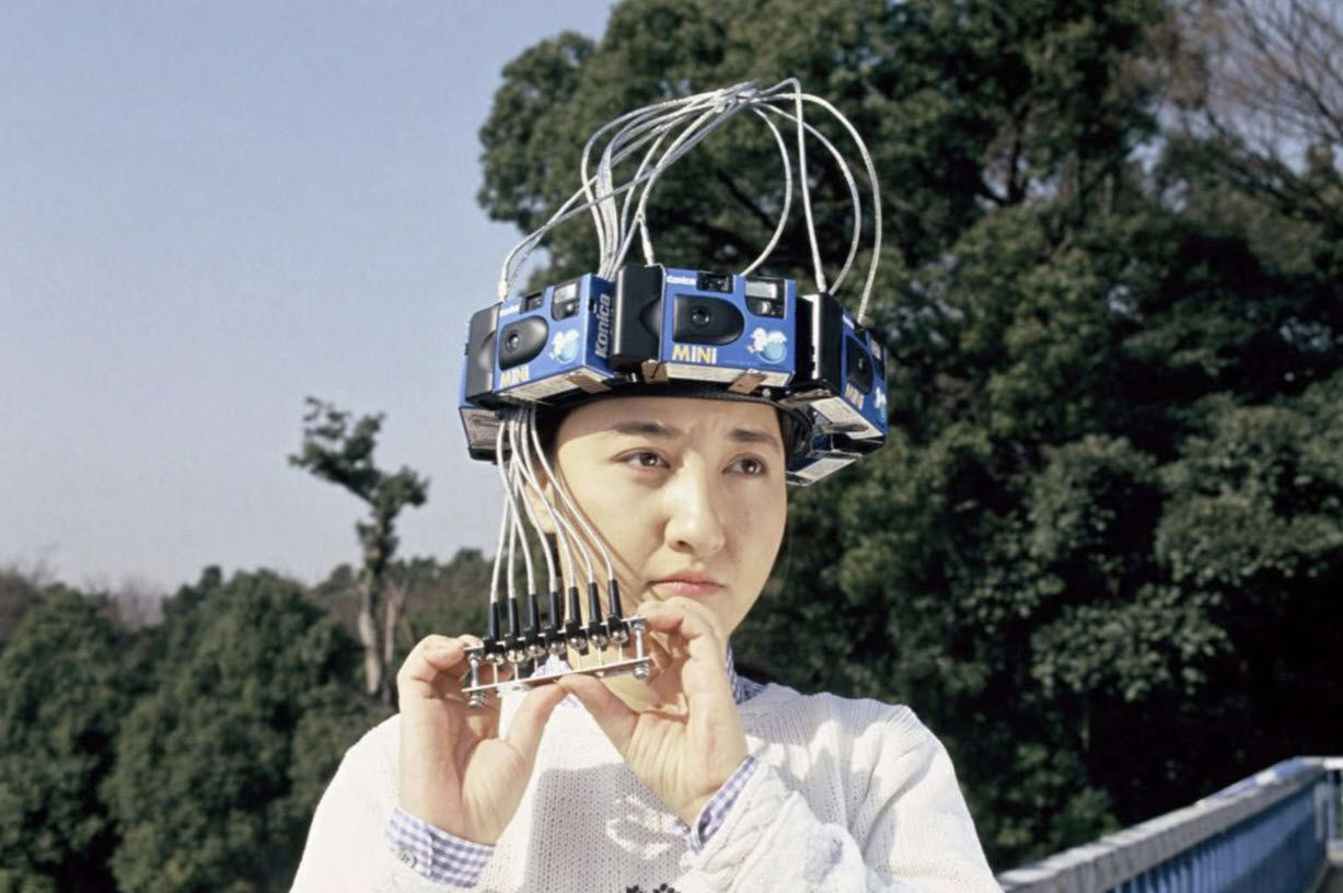 Woman wearing a headband made of disposable cameras